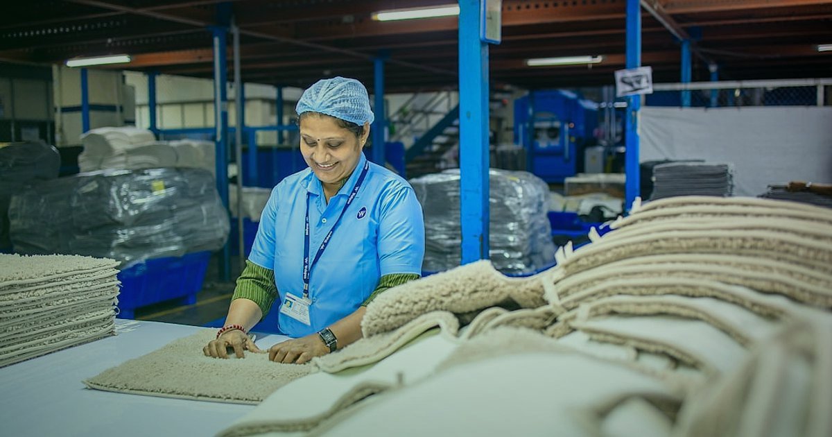 2026'da İç Giyim & Fantezi Ürünleri Online Satış Kuralları: Kârlı Bir Başlangıç Rehberi - person examining eco-friendly fabric rolls sustainable fashion