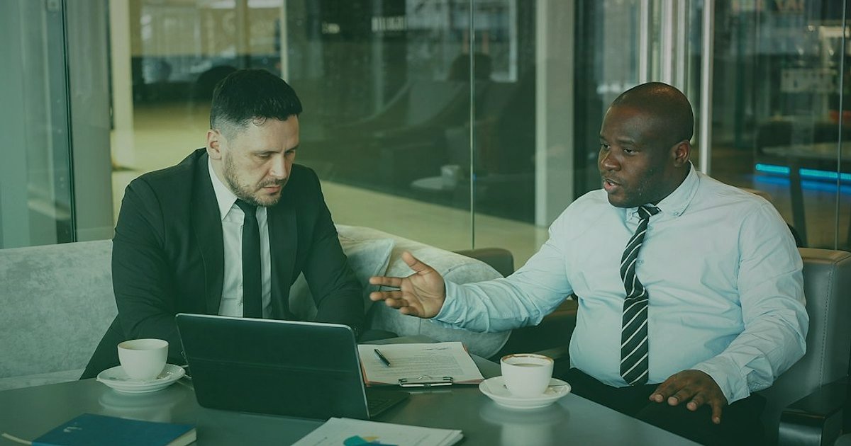 2026'da Zirveye Çıkın: Dropshipping Tedarikçi Firmaları Rehberi - two business partners shaking hands across a table with a tablet displaying a supplier evaluation checklist
