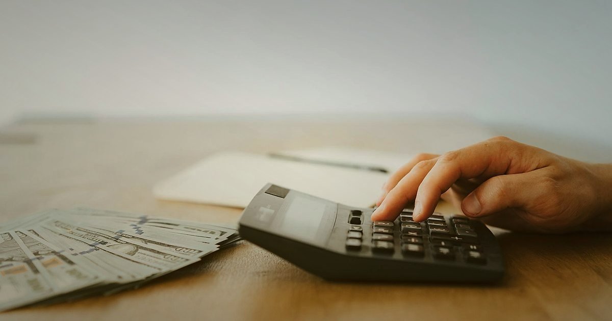 Dropshipping'de Hata Yapma 2026: Tuzakları Aşın, Başarıyı Yakalayın! - close-up of a person calculating expenses on a calculator with stacks of Turkish Lira banknotes