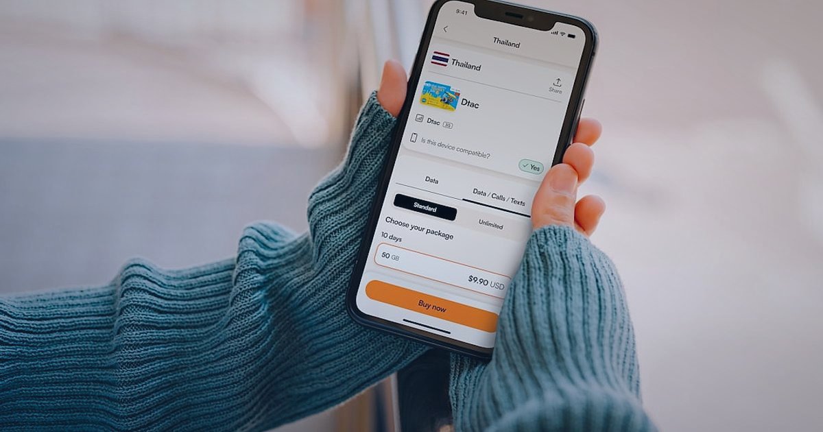 Dropshipping.gen.tr Avantajları 2026: E-Ticarette Neden Lideriz? - person holding a smartphone displaying a shopping cart icon