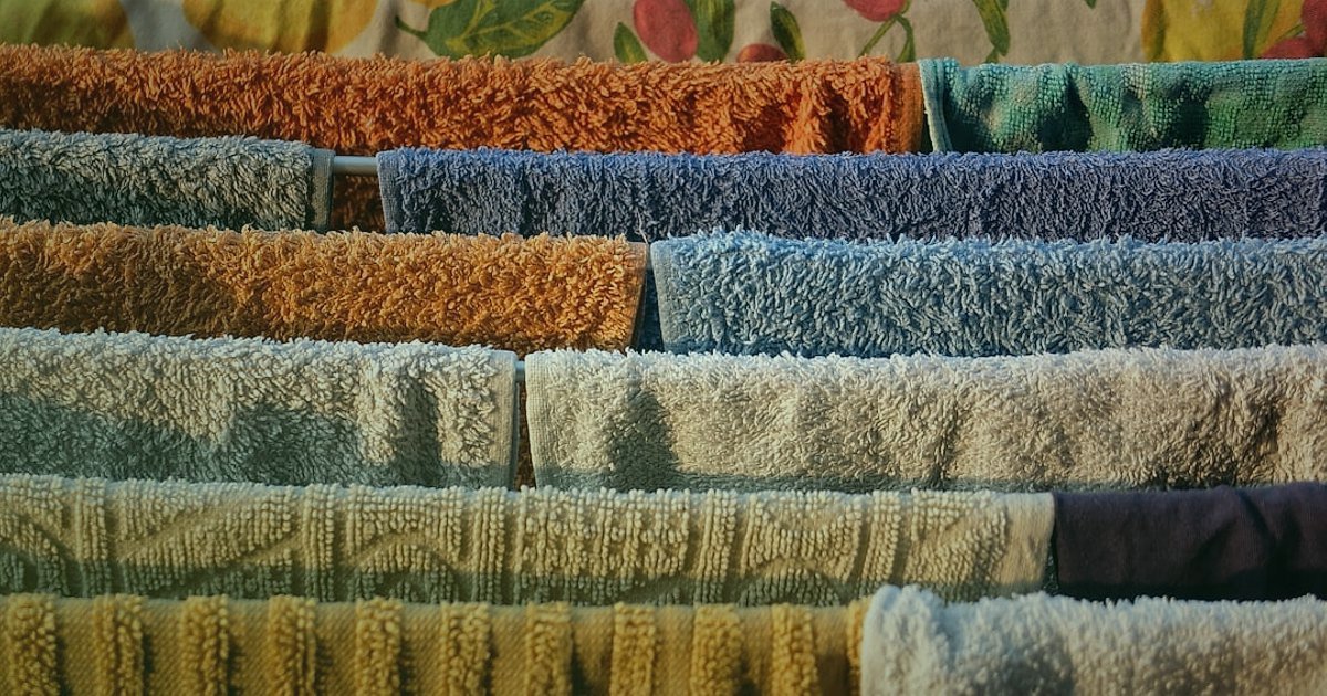 Nevresim & Ev Tekstili Dropshipping: 2026'da Kaçınılması Gereken Hatalar - price tags hanging from a rack of colorful towels
