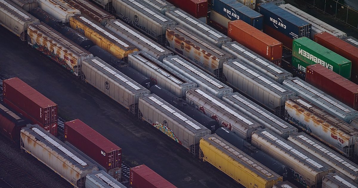Pazaryeri Başarı Stratejileri 2026: Rekabette Öne Çıkın! - aerial view of a busy logistics hub with trucks and shipping containers