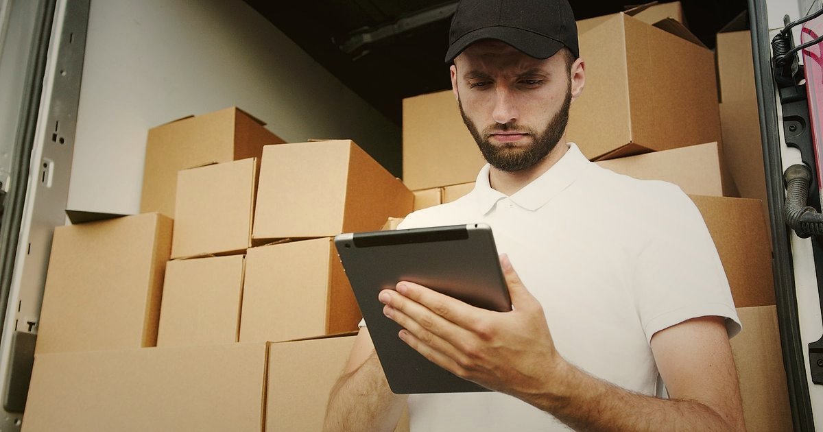 Sandalet & Terlik Stok Sorununu Aşın: 2026 Tedarik Zinciri Süreklilik Rehberi - person using a tablet to track shipments in a logistics hub